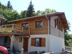 una casa que se está construyendo con una terraza en la parte superior en Chalet neuf 6 personnes, en Mont-Saxonnex