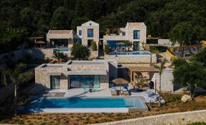 an aerial view of a house with a swimming pool at Mimi and Coco Villas Corfu in Paramonas