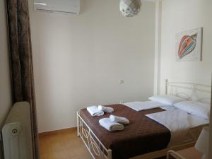 a bedroom with a bed with towels on it at Sofirene Sea Scape in Batsi