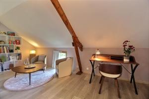 a living room with a desk and a table at La Longère de La Chevallerais in La Chevallerais