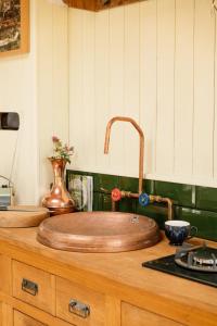 a wooden sink on top of a kitchen counter at Abbeyfield Horsebox Glamping in Morpeth +20 photos