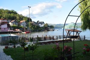 a view of a lake with a dock and houses at Casa Rares in Orşova