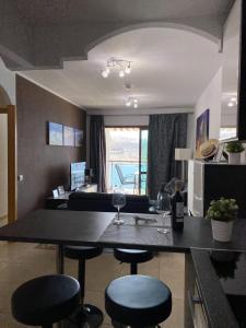 a living room with a table with two wine glasses at Four Seasons - Playa del Cura in Playa del Cura