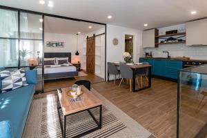 a living room with a couch and a table at Botun Luxury Apartment in Šibenik