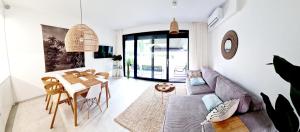 a living room with a table and a couch at BOHO MARE Apartament Pobierowo in Pobierowo