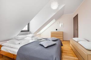 a bedroom with two beds in a attic at Happy Stay Old Town Tartaczna 235 in Gdańsk