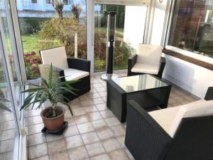 a patio with chairs and a table and a potted plant at Maxbed in Flensburg