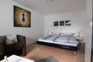 a bedroom with a bed and a chair at Maxbed in Flensburg