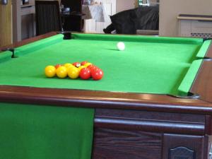 a pool table with balls on top of it at Macbeth Arms in Lumphanan