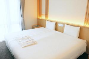 Rúm í herbergi á Henn na Hotel Premier Kyoto Eki Hachijoguchimae