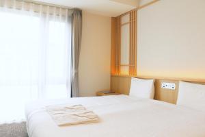Rúm í herbergi á Henn na Hotel Premier Kyoto Eki Hachijoguchimae