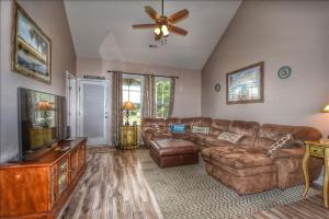 a living room with a couch and a flat screen tv at 612 Egret Run Cabin in North Myrtle Beach