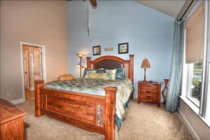 a bedroom with a wooden bed and a window at 612 Egret Run Cabin in North Myrtle Beach