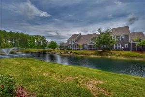 a house with a pond in front of a house at 612 Egret Run Cabin in North Myrtle Beach