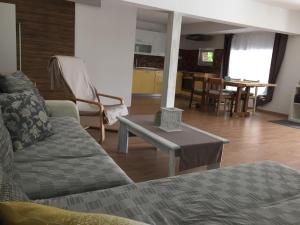 een woonkamer met een bank en een tafel bij Hillside Bio Resort Apartment with Mountain View in Prebold