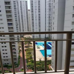 balcón con vistas a la piscina y a los edificios en Mediterania Garden Residence 2, en Yakarta
