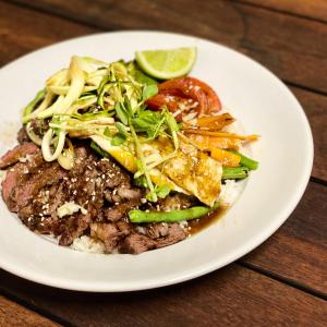 Un plato de comida con carne y verduras en una mesa. en The Coorow Hotel, en Coorow