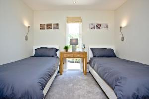 A bed or beds in a room at Haldon Forest Lodge, Exeter