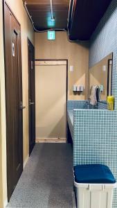 a bathroom with a sliding door in a room at Hostel Furoya in Osaka