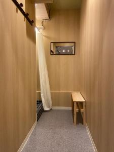 a hallway with a table and a window on the wall at Hostel Furoya in Osaka
