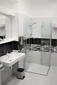 een witte badkamer met een wastafel en een douche bij Apartmány PAPÍK in Nová Bystřice