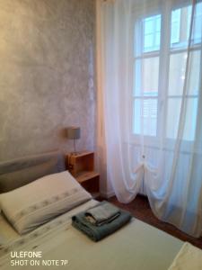 a bedroom with a bed and a window with curtains at A Casa di Irene in Como