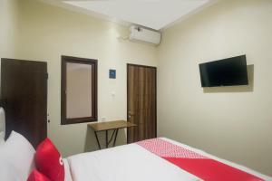 Tempat tidur dalam kamar di Super OYO 3354 Homia Residence