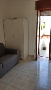 a living room with a couch and a sliding glass door at Appartamento Monticello Vista Mare in Scalea