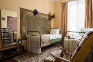a bedroom with two beds and a mirror and a chair at Tsentralnaya Hotel in Odesa +49 photos