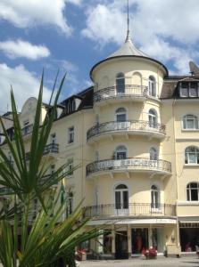 a large building with a tower on top of it at Hotel Haus Reichert in Baden-Baden
