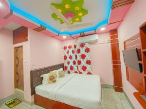 a bedroom with a bed and a ceiling with a tv at Hotel As Shams International in Dhaka
