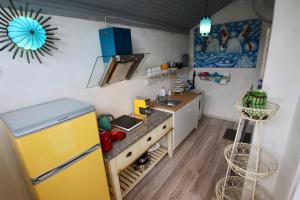 a kitchen with a yellow refrigerator and a sink at Smiling house & Baltic beach in Jūrmala