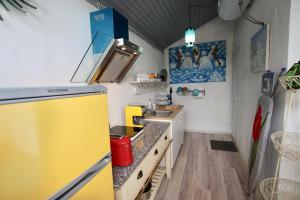 a kitchen with a sink and a yellow refrigerator at Smiling house & Baltic beach in Jūrmala +11 photos