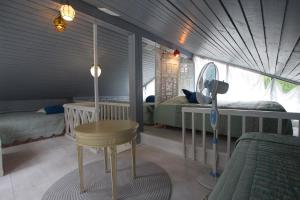 a room with two beds and a table in a tent at Smiling house & Baltic beach in Jūrmala