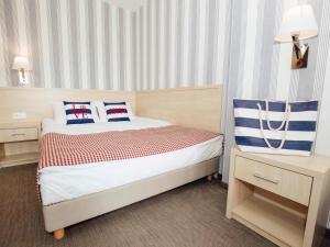Łóżko lub łóżka w pokoju w obiekcie Porto Marina