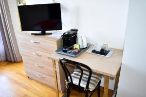 a desk with a television on top of a dresser at Hostellerie d'Orzival in Vercorin