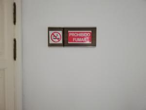 a sign on a white door with a no smoking sign at Sun and Sea House 3 Rooms & Wifi in Arinaga