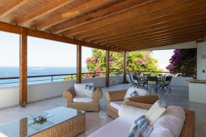 a patio with furniture and a view of the ocean at Villa Noria in Aghia Marina