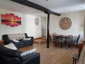 a living room with a couch and a table at Old Printers Ruthin in Ruthin