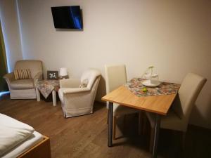 a room with a table and chairs and a bed at HopfenErlebnisHof in Altmannstein
