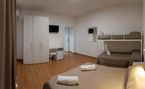 a bedroom with two bunk beds and a living room at Prestige house in Scalea +22 photos