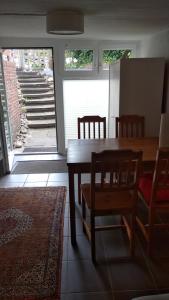 a dining room with a wooden table and chairs at Bel Air in Norderstedt