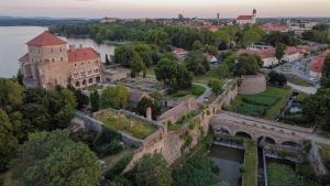 an aerial view of a castle and a river at Platán Udvarház - Platán Tata in Tata