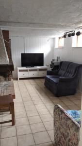 a living room with a couch and a flat screen tv at Bel Air in Norderstedt