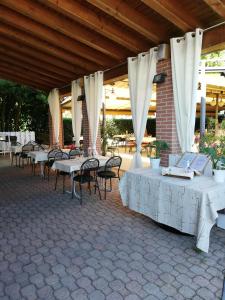 a group of tables and chairs under a pavilion at Albergo Villa Eva in Costermano