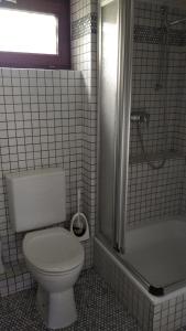 a white bathroom with a toilet and a shower at Bel Air in Norderstedt +3 photos