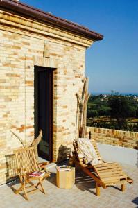 two chairs sitting on the patio of a house at Casa De Campo in Mosciano SantʼAngelo +30 photos