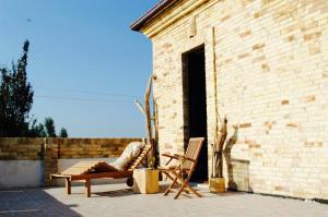 a person laying in a chair on a patio at Casa De Campo in Mosciano SantʼAngelo