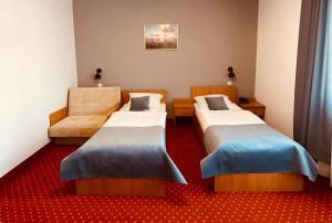 En eller flere senge i et værelse på Hotel Solny