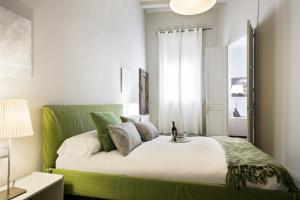 a bedroom with a bed with a green headboard at Ola Living Gaudi in Barcelona